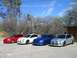 1996 Ford Probe - A lineup of four Dodge SRT-4 sedans in various colors under a bright blue sky.