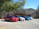 1996 Ford Probe - A lineup of four Dodge Neon SRT-4s are parked in a gravel lot with a rustic building and desert landscape in the background.