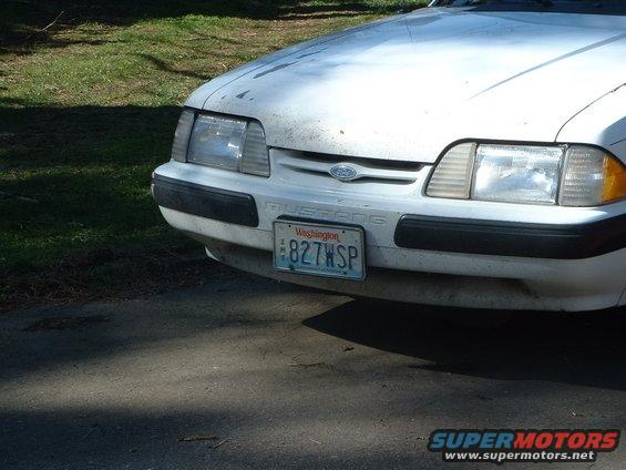 White Ford Mustang front with Washington license plate 827WSP and visible 'Mustang' badging