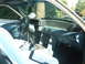 1987 Ford Mustang - The interior of a car shows the dashboard, steering wheel, and gear shifter.