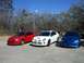 1996 Ford Probe - Three Dodge SRT-4 Neons are parked side-by-side outdoors on a sunny day.