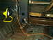 1985 Ford Bronco - Vehicle interior being worked on, showing stripped flooring and a work light.