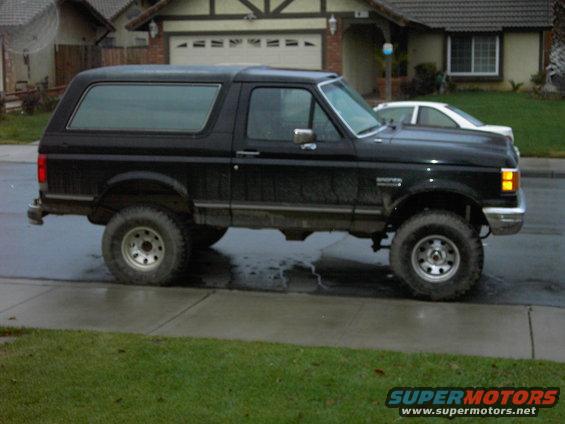 Side view of a black 1988 Ford Bronco with a 4-inch lift kit