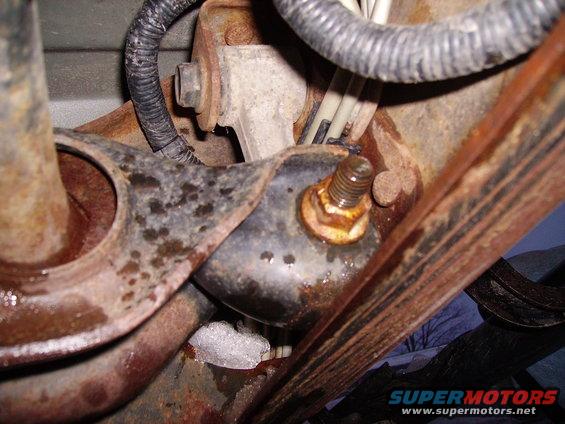 rusted metal bracket with bolt and wiring harness
