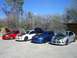 1996 Ford Probe - A row of four Dodge Neon SRT-4s, each with its hood raised, sits under a clear blue sky.