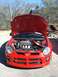 1996 Ford Probe - The front of a red Dodge Neon SRT-4 is shown with its hood open, revealing the engine compartment.