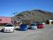 1996 Ford Probe - A lineup of four Dodge SRT-4s are parked in a dusty lot with a mountain range in the background.