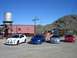 1996 Ford Probe - A quartet of Dodge Neon SRT-4s are lined up in front of a vintage train car and a water tower under a clear blue sky.