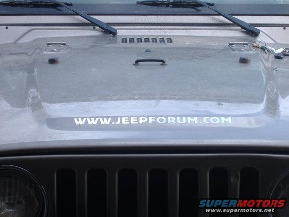 Gray Jeep Wrangler hood with WWW.JEEPFORUM.COM sticker and grille