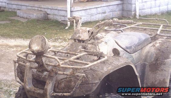 Mud-covered ATV front view