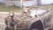 2005 Honda RANCHER - This ATV is heavily covered in mud, obscuring its details and making identification difficult.