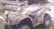 2005 Honda RANCHER - This 2005 Honda Rancher ATV is heavily covered in mud, suggesting recent off-road use.