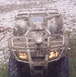2005 Honda RANCHER - This ATV is heavily covered in mud, obscuring its make and model year.