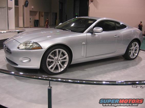 Silver coupe with chrome wheels and side vents, viewed from the front three-quarter angle