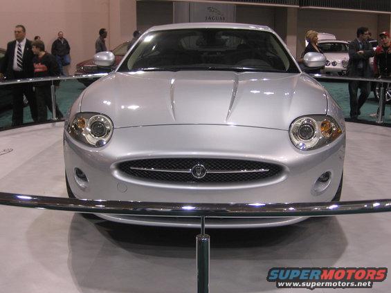 Silver Jaguar XK front view with mesh grille and round headlights