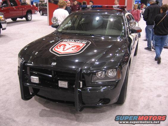Black police car with push bumper and ram logo on hood