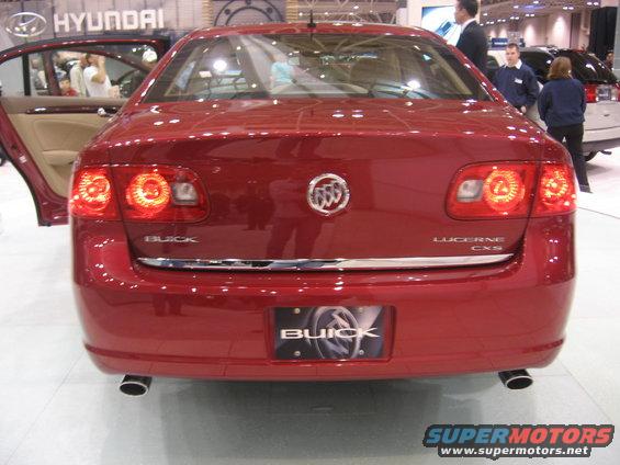 Red Buick Lucerne CXS rear view with chrome trim and dual exhaust pipes