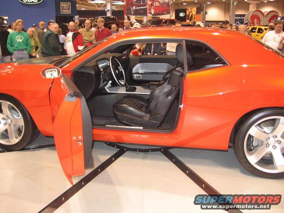 Orange muscle car interior with black leather seats and dashboard