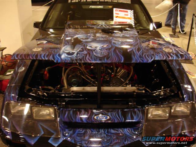Front view of a black 1981 Ford Mustang with custom skull airbrushing on the hood and grille