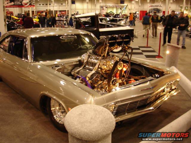 Customized 1965 Chevrolet Impala with chrome engine and lowered suspension