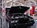 1981 Ford Mustang - A black coupe is displayed with its hood open, revealing the engine bay.