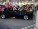 1981 Ford Mustang - A modified black coupe with custom flame graphics is displayed with its hood and trunk open.