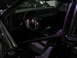 1981 Ford Mustang - The interior of a modified car features a roll cage and custom steering wheel.