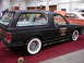 1981 Ford Mustang - Custom black SUV with whitewall tires and chrome wheels displayed indoors.