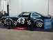 1981 Ford Mustang - This race car features a prominent number 43 on its side and a blue informational placard next to it.