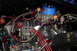 1981 Ford Mustang - Close-up view of a modified engine bay with various aftermarket parts and braided hoses.