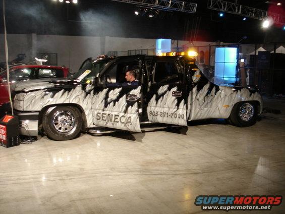 Pickup truck with custom black and white flame graphics, "SENECA" text on door, and phone number