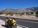2000 Honda CBR-RR - Motorcycle parked on a desolate road with a mountain range behind it under a clear blue sky.