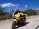 2000 Honda CBR-RR - A yellow sport motorcycle is parked on a dirt road with a scenic mountain range and blue sky in the background.