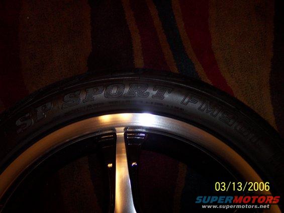 Close-up of a tire with 'SP SPORT FM901' text and a silver and black rim