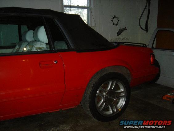 1986 Ford Mustang convertible, red exterior, black top, light interior visible from side view