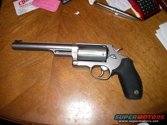 dscn4528.jpg My new tractor gun, Taurus M410 Tracker.  Stainless, chambered in 45 Long Colt & .410 guage shotgun.  6 1/2" barrel, with orange high-viz front sight.