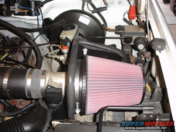 Engine bay showing a K&N air filter and intake tubing. Visible text: SUPERMOTORS.NET