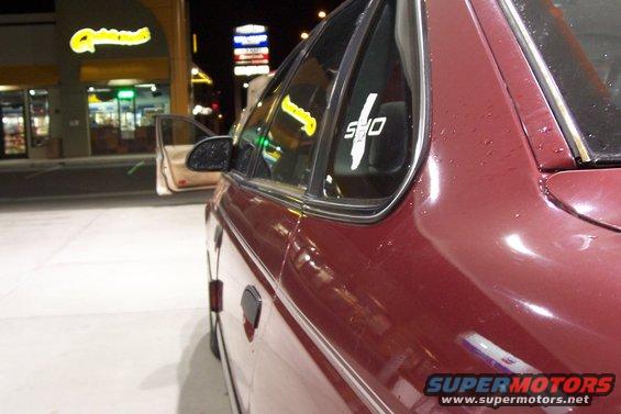 Red sedan side view with SHO decal on rear window