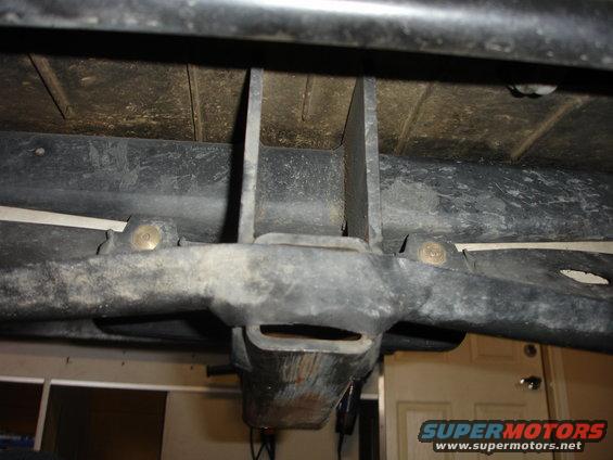 Underside of vehicle frame with tow hitch receiver visible