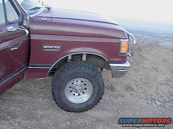 Maroon 1988 Ford Bronco 3q-front view showing fender badge and wheel