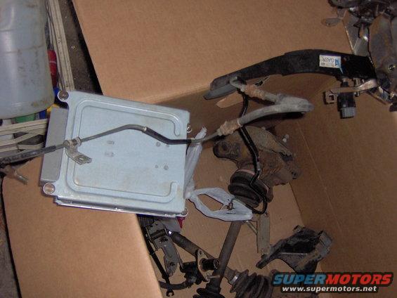 ECU and some suspension components in a cardboard box