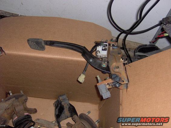 Brake pedal assembly with wiring connectors inside a cardboard box