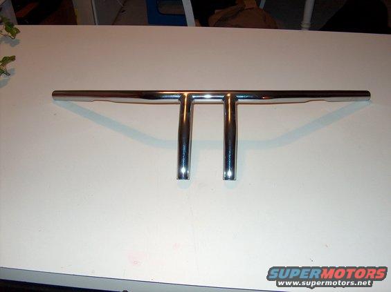 Chrome T-bar handlebars on a white surface