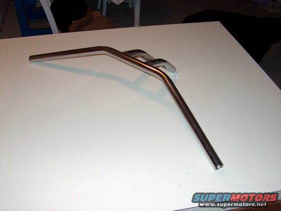 Chrome motorcycle handlebars on a white surface