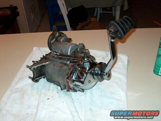Motorcycle transmission with shifter lever and foot peg, resting on a white towel