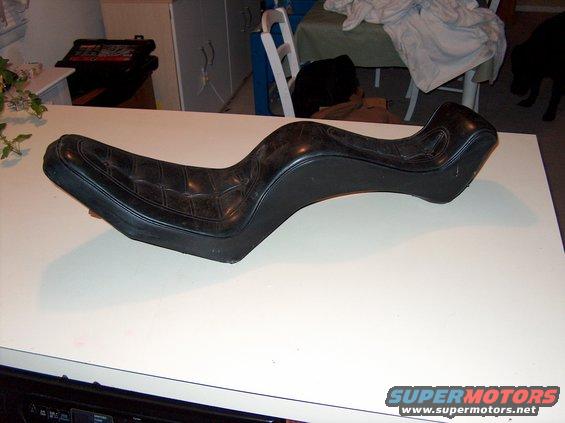 Black motorcycle seat with diamond stitching on a white surface
