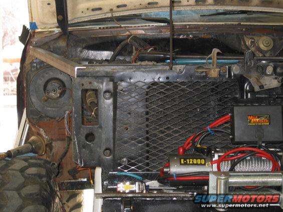 Engine bay with winch, radiator, and wiring visible