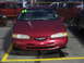1995 Ford Thunderbird - A red sedan is parked in a lot, with a '97 sticker visible on the windshield.