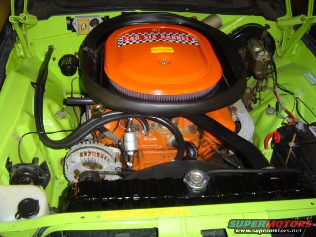 Engine bay with orange air cleaner and "340 SIX BARREL" text, lime green paint, and black radiator