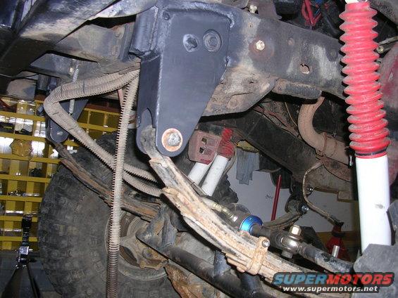 1986 Jeep J-10 undercarriage with leaf springs, shocks, and steering linkage